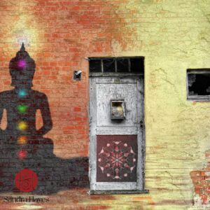 Shadow of a meditating person with chakras projected onto an old wall – a symbol of healing through Ashtanga Yoga as psychosomatic therapy